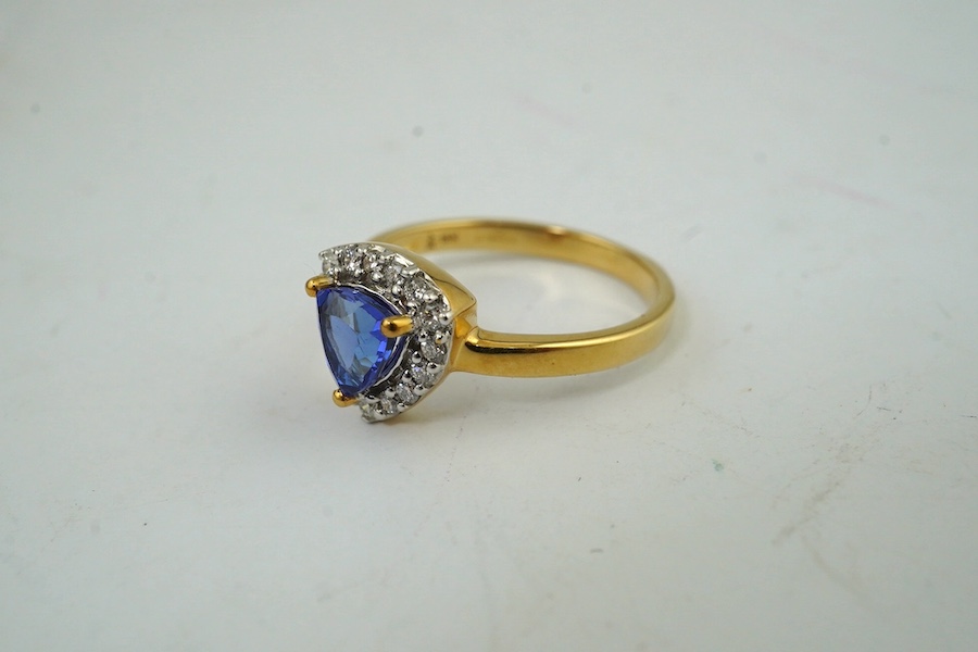 A modern 18ct gold, tanzanite and diamond cluster set ring, with AnchorCert report estimating the tanzanite to weight 1.01ct, size O, gross weight 4.4 grams. Condition - good